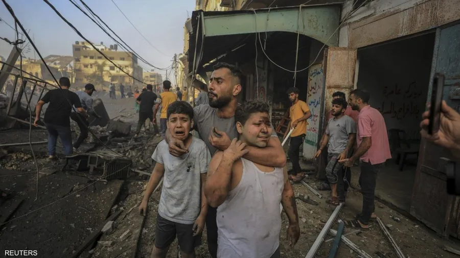 صورة حول : صور الألم: جوائز تكرم رويترز لتوثيق مأساة "حرب غزة" فلسطيني يحتضن ابني شقيقه بعد قصف إسرائيلي
